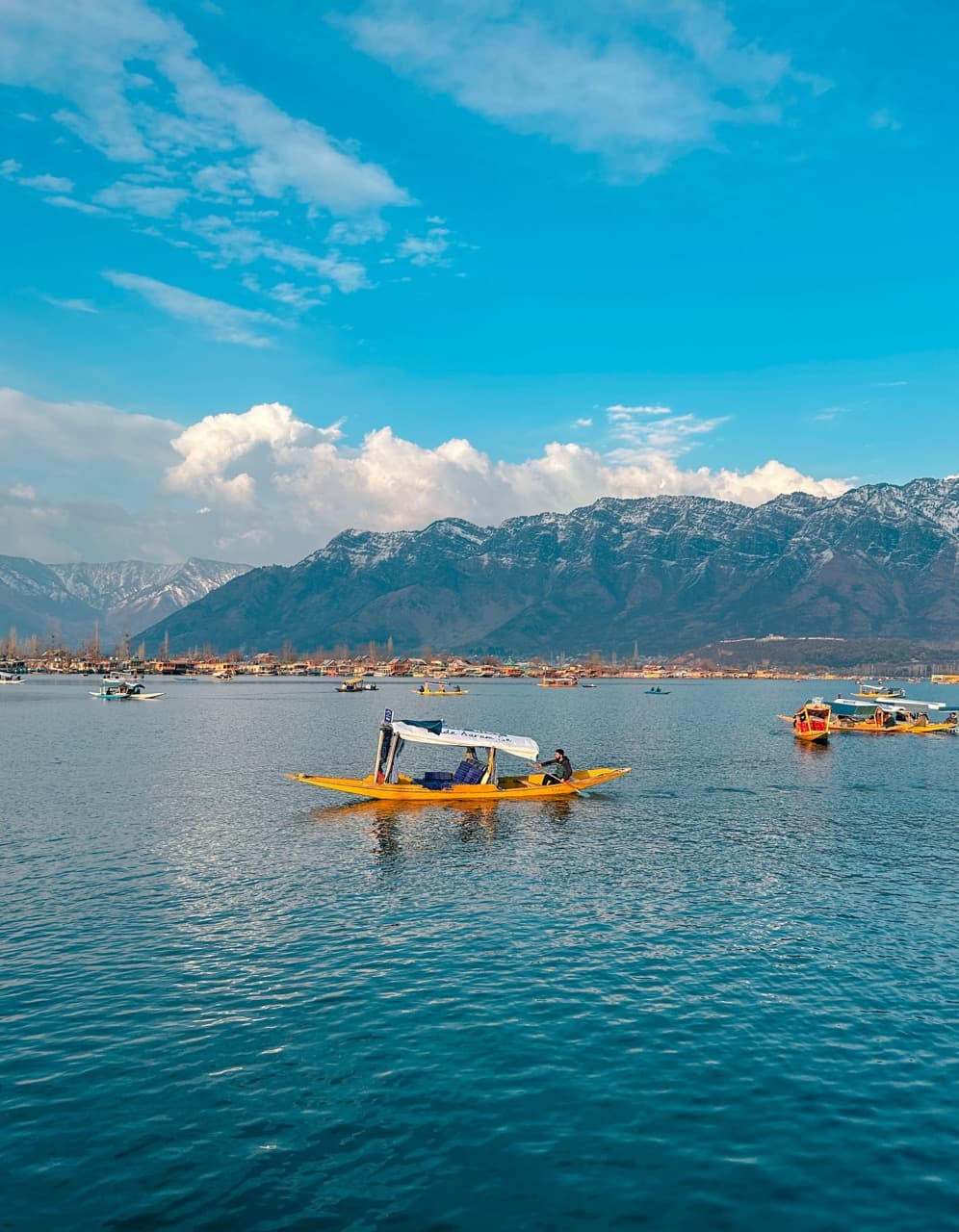 A shikara crossing Dal Lake at golden hour